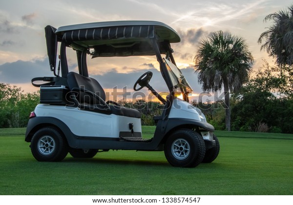 \
Golf cart on\
Florida golf course at\
sunset