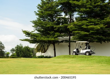 Golf Cart Park In Front Of Green Golf Court, Landscape.