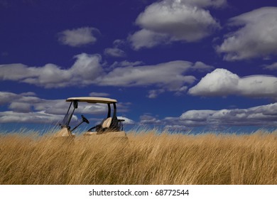 Golf cart parked on a grassy hill top on a sunny day,  Idaho - Powered by Shutterstock