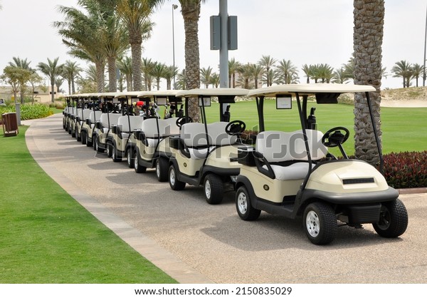 Golf carts. All lined up ready for a\
tournament here on a course in Abu Dhabi,\
UAE