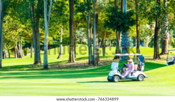 a golf carts on a golf\
course blur.