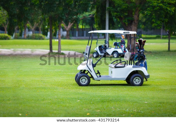 Golf carts on green
field