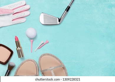 Golf club, golf ball, golf glove and ladies accessories on blue background from above, ladies day