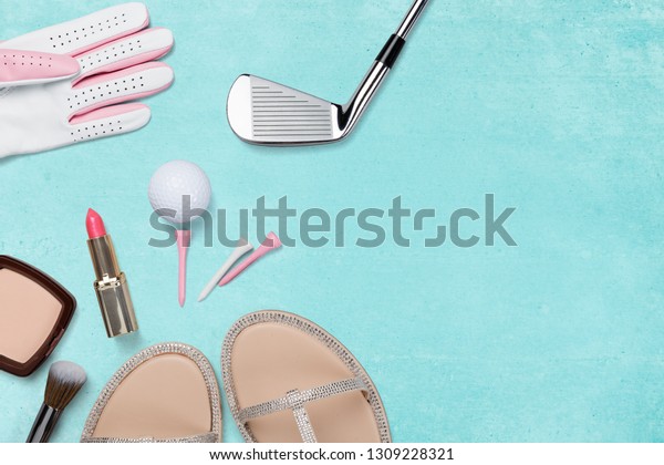 Golf club, golf ball,\
golf glove and ladies accessories on blue background from above,\
ladies day