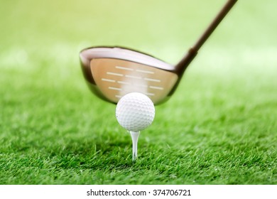 Golf Club And Ball On Green Grass