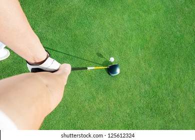Golf club and golf ball  ready to putting ball, top view