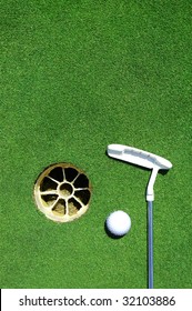 Golf club, hole, white ball on green grass with room for copy space