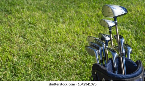 Golf Club, Sticks In A Bag On Green Grass Golf Course Background, Close Up View.