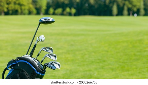 Golf clubs in a golf bag isolated. Set of golf clubs for a golfer. Copy Space. green Background. Close-up. High quality photo