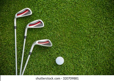 Golf clubs and ball in grass, shot from aerial view