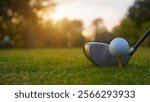 Golf clubs and golf balls on a green lawn in a beautiful golf course with morning sunshine. Close up of golf equipment on green                                 