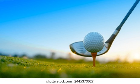 Golf clubs and golf balls on a green lawn in a beautiful golf course with morning sunshine. Close up of golf equipment on green grass.                                - Powered by Shutterstock