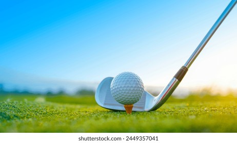 Golf clubs and golf balls on a green lawn in a beautiful golf course with morning sunshine. Close up of golf equipment on green grass.                                - Powered by Shutterstock