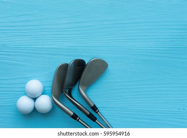 Golf concept : golf balls, golf clubs on wooden table. Top view with copy space.
