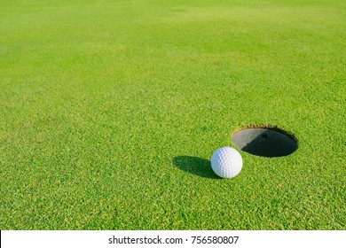 Golf Course With Golf Ball On Putting Green. Golf Is A Sport To Play On The Turf