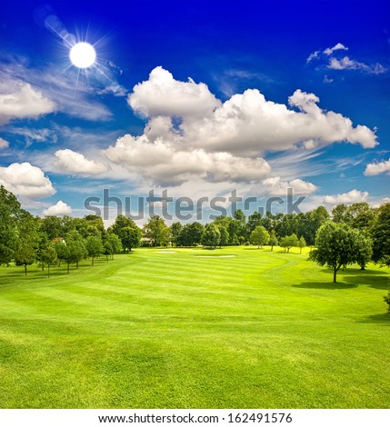 golf course and blue sunny sky. european green field landscape