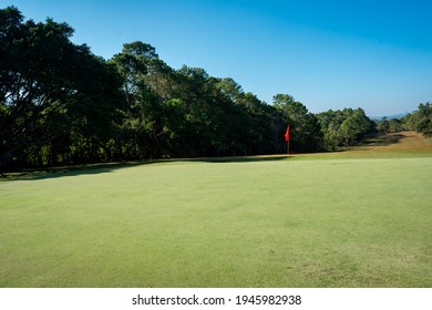 Golf course for golfer playing sport, bunker sand before green golf, lawn fairway and layout landscape course, light rays of sunny of sunrise morning is beauty, green grass and forest on hills on sky