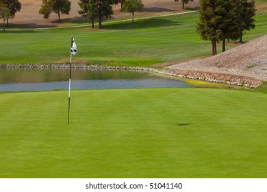 Golf Course Green Next To A Water Hazard