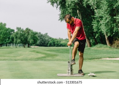 Golf Course Maintenance, Greenskeeper Cutting A Golf Hole