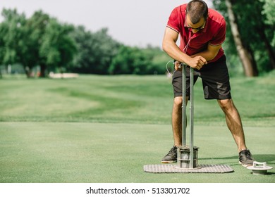 Golf Course Maintenance, Greenskeeper Cutting A Golf Hole