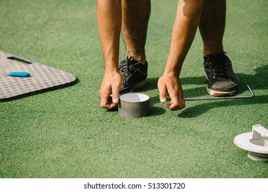 Golf Course Maintenance, Greenskeeper Cutting A Golf Hole