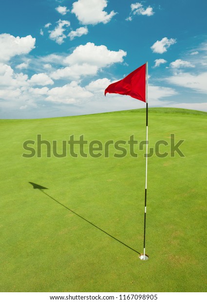 Golf course with red\
flag