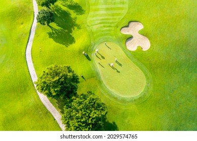 Golf course sport, green grass and trees on a golf field, fairway and putting green top view, Bangkok Thailand. bird view over Golf course in the tropical asia.