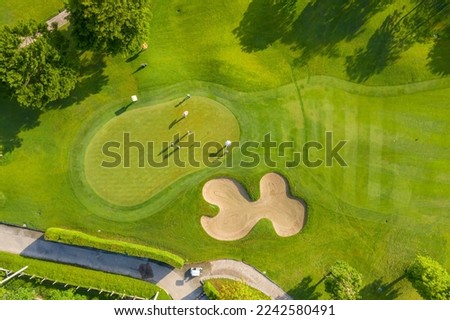Golf course sport, green grass and trees on a golf field, fairway and putting green top view, Bangkok Thailand. bird view over Golf course in the tropical asia.