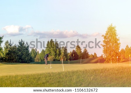 Similar – A tranquil aerial view of a lush golf course fairway, bathed in the warm glow of sunset. Ideal for themes of relaxation, nature, and sports, this image captures the peaceful beauty of the golfing experience.