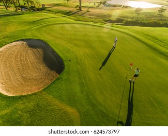 Golf Course Top View With Players. Aerial View Of Golfers On Putting Green.