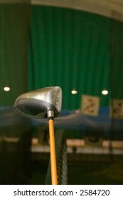 Golf Driver With The Indoor Driving Range As A Background.