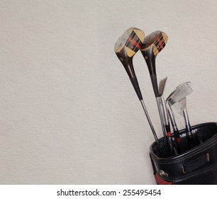 Golf Equipment. Retro Golf Clubs In An Old Leather Bag. Vintage Paper Background.