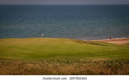 Golf Flag Overlooking The Ocean In Cape Breton 