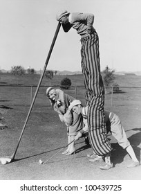 Golf Game With Man On Stilts