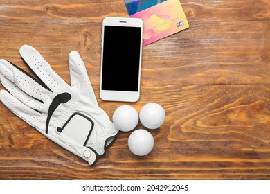 Golf Glove, Mobile Phone And Credit Cards On Wooden Background. Concept Of Sports Bet