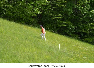 Golf Player At 9 Hole Golf Course Looking For Golf Ball At City Of Zurich At Springtime. Photo Taken May 18th, 2021, Zurich, Switzerland.