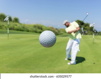 Golf Player Hitting The Ball