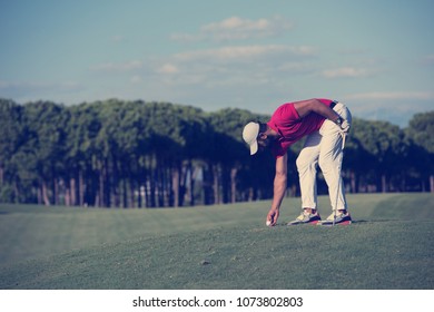 golf player hitting shot with driver on course at beautiful sunny day
