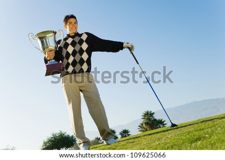 Golf player holding a trophy