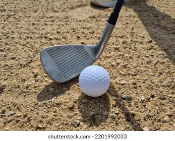 Golf Players Hitting Ball With Sandblasting. Playing Golf Out Of The Sand And Getting Ready To Hit