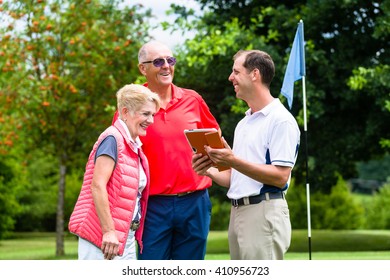 Golf pro with senior woman and man analyzing results - Powered by Shutterstock