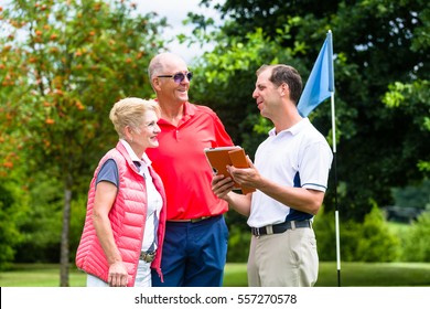 Golf pro with senior woman and man analyzing results - Powered by Shutterstock