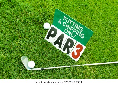 Golf Putting and Chipping Sign on putting green. Golf Club and ball by Par 3 sign. 