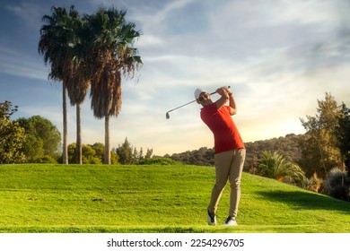 golf shot man. professional golf swing. Golf player teeing off. Front view of golfer finishing swing with a smile. Full length of golfer playing on the course. Golfer hitting golf shot with club