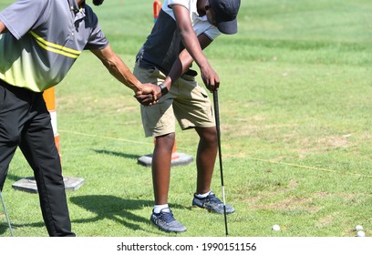 golf swing instruction giving to an African American
