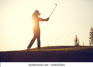 Golf swing on the course. Golfer performs a golf shot from the fairway. Sunny summer day. Concept: sport, relax, tourism, welfare. - Powered by Shutterstock