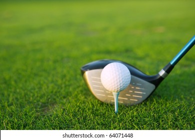 Golf Tee Ball Club Driver In Green Grass Course Closeup