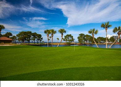 Golf with water hazards and palm trees