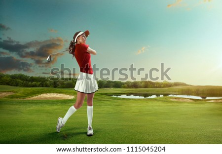 GOLF. Woman playing golf on a golf course in the sun