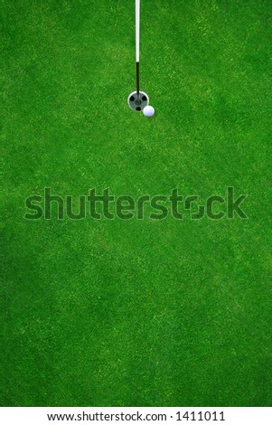 Golfball almost in the hole on a beautiful golf course - top view